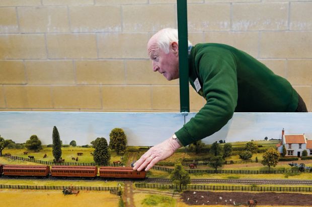A model train enthusiast works on their railway to illustrate Scholars ‘stumble through’ as British Library tools stay offline