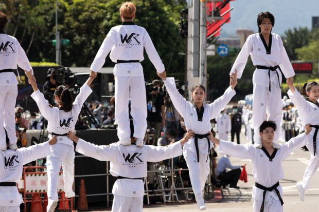 A group of youngTaiwanese from a martial art organization show their skills to illustrate Taiwanese ‘merger’ seen as a model for struggling universities