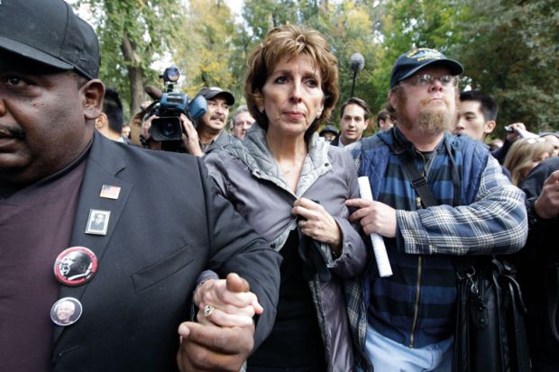  Linda Kateh is,escorted from the stage after she spoke during a rally on campus in Davis to illustrate Katehi: the political is not the personal
