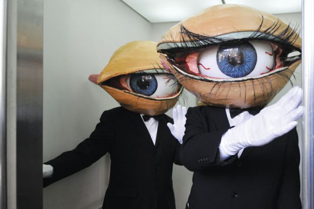Performers wearing a large eyeball in a lift in Yokohama