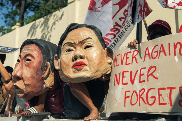Protesters march to the People Power Monument to commemorate the 36th anniversary of People Power that ousted dictator Ferdinand Marcos to illustrate Academics warn against historical revisionism in Philippines