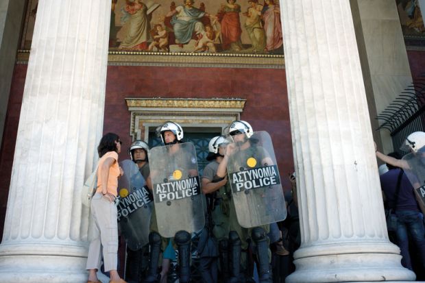 Police block the entrance to the central Athens university to illustrate Greeks fed up with anarchy on campuses 