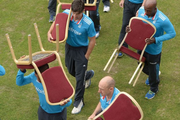 England  team carry back their chairs after a team photo.