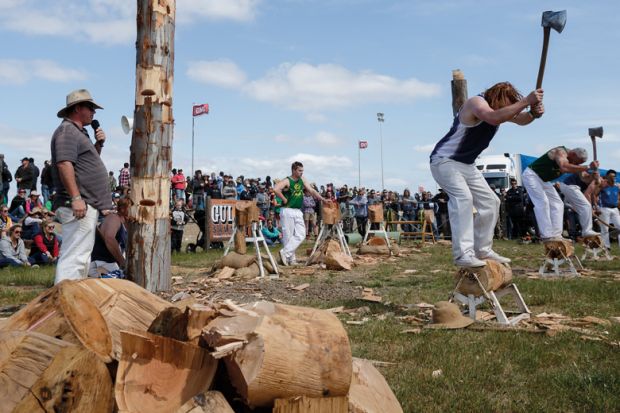  Men compete in a wood chopping competition Deniliquin, Australia to illustrate Immigration risk ratings downgraded at 11 Australian universities