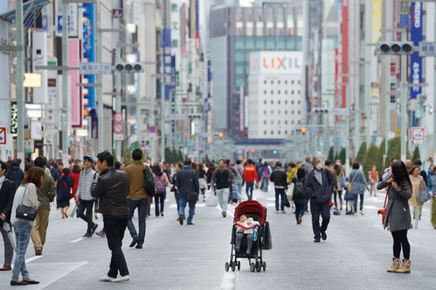 Baby alone in a pram in the city of Tokyo, Ginza to illustrate Japanese women with student loans more likely to delay child-rearing