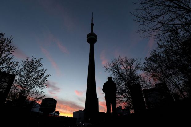 The CN Tower is seen at sunset in Toronto to illustrate Canadian campuses add black student spaces
