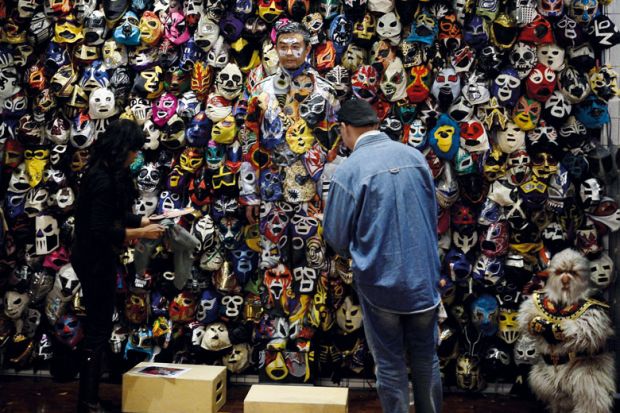 Chinese man camouflaged with painted masks on his body to illustrate What next for US-China research ties post-Lieber?