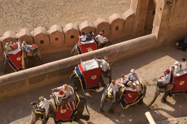 Tourists ride on elephants up to the Amber Fort, Jaipur, India.