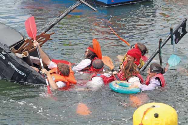 Boat sinking at the Cardboard Boat Regatta at Port-Rhu in Douarnenez, France to illustrate French funding cuts ‘contradict’ Macron’s research pledge