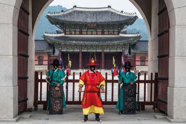 Guards of Gyeongbokgung stand at the closed gates of the palace to illustrate Korean universities hit with overseas recruitment bans