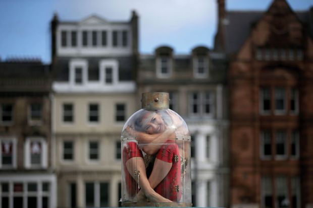  Contortionist Odka, from Cirque Berserk, sitting in a tiny bottle to illustrate ‘Pod-sized’ rooms plan to reduce UK student rents
