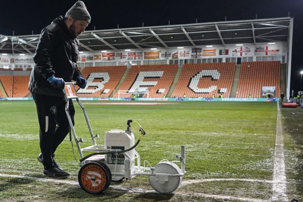 Ground staff paints the white lines of the football pitch in Blackpool to illustrate What can academics and universities learn from Jo Phoenix’s employment tribunal victory