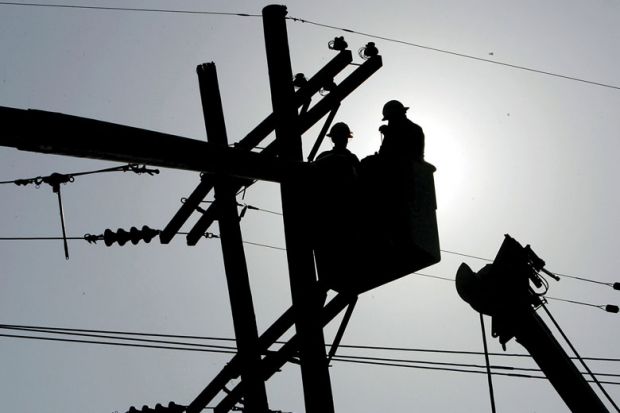 Utility workers repair a power line to show The 10-year programme aims to reshape America’s economy by spending big on transport projects, advanced manufacturing and clean energy.
