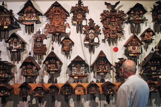  A man looks at cuckoo clocks to illustrate Quality questions as publisher’s growth challenges big players