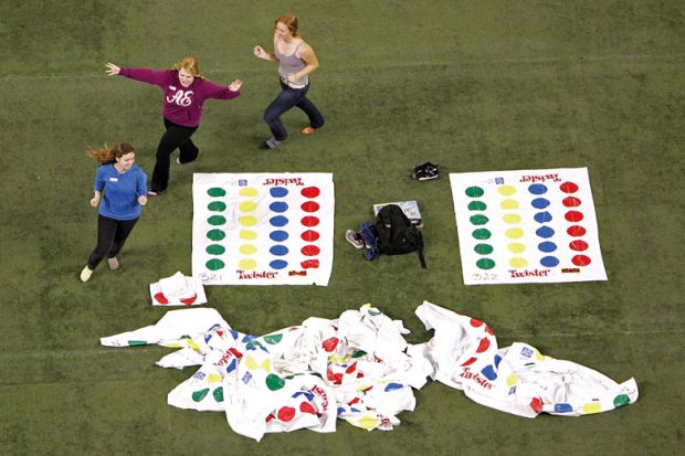 Volunteers run around prior to a failed attempt to break the World Twister record