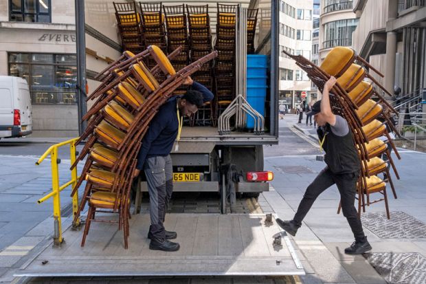 Contractors load tall stacks of event chairs into the company lorr to illustrate English university severances top £100m