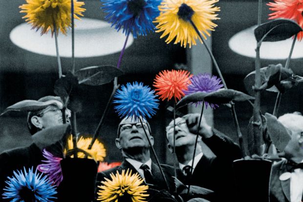 Four judges examine several dahlias during the competition in 1968 as a metaphor for graduate employment outcomes.