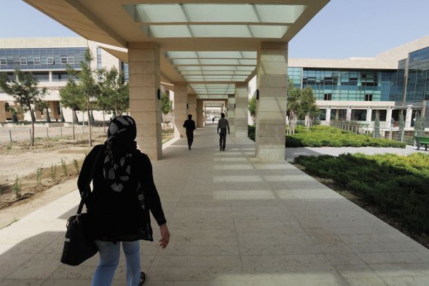 Student walks through campus during her fourth year on scholarship at the American University of Iraq to illustrate Afghan students ‘in doldrums’ at Iraqi university