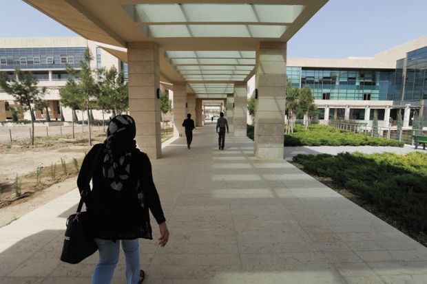 Student walks through campus during her fourth year on scholarship at the American University of Iraq Student walks through campus during her fourth year on scholarship at the American University of Iraq to illustrate Afghan students ‘in doldrums’ at Iraqi university