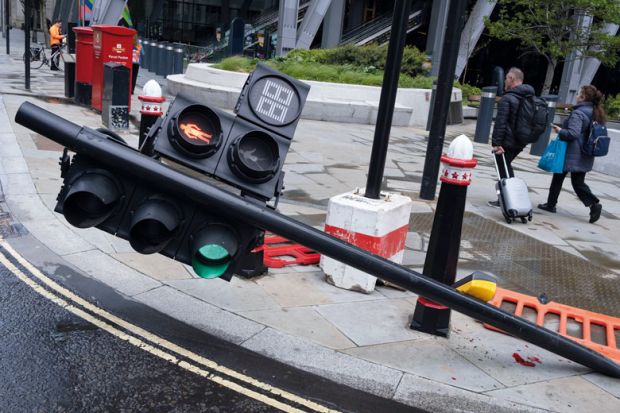 Traffic lights have been knocked over on Leadenhall in the City of London to illustrate International students bear brunt of marking crisis