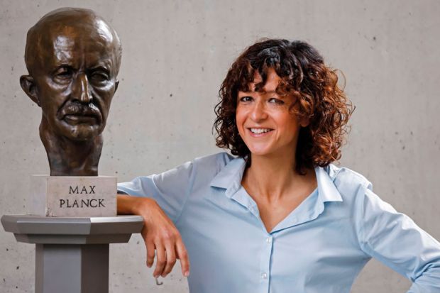 French researcher in Microbiology, Genetics and Biochemistry Emmanuelle Charpentier poses for photographers next to a bust of Max Planck in Berlin as described in the article