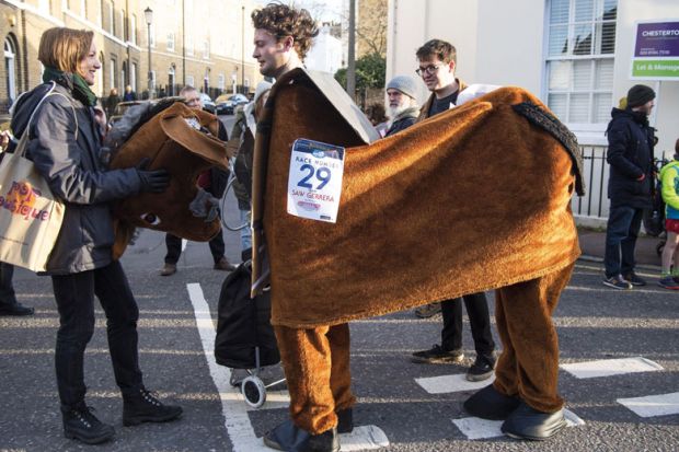 Person holds the horse costume head in the annual pantomime horse race to illustrate Academics hatch plan to save disbanded research centre