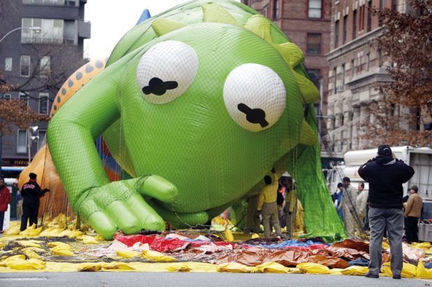 A giant Kermit the Frog balloon with helium is low on the ground at Macy's Thanksgiving Day Parade n New York City to illustrate US debt pact throws campuses back in crisis