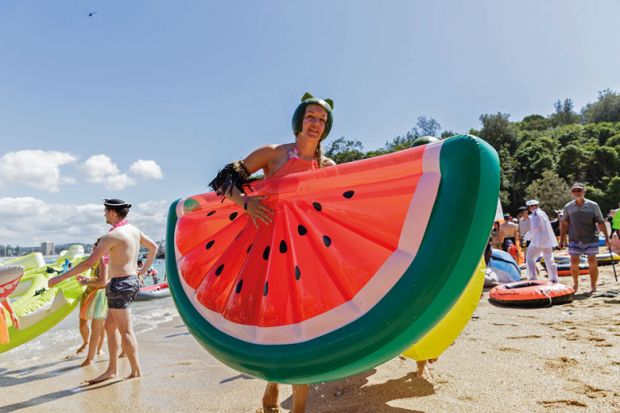 Person holding inflatable watermelon for Covid ‘just a blip’ in rising Australian vice-chancellor earnings
