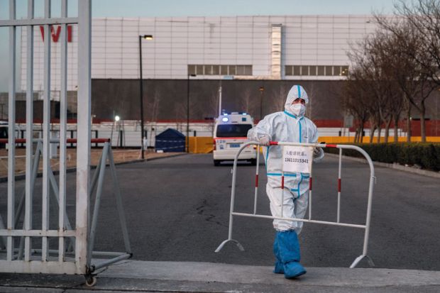 A worker places a barrier in Beijing, China A worker places a barrier in Beijing, China to illustrate ‘Collective crawling’ and cardboard dogs ‘are creative protests’
