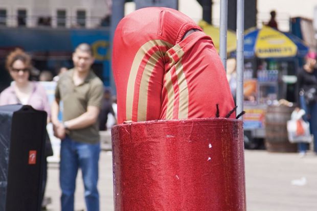 Street performer squeezes into a tube to illustrate Spain’s squeeze on precarity ‘impossible’ without funding