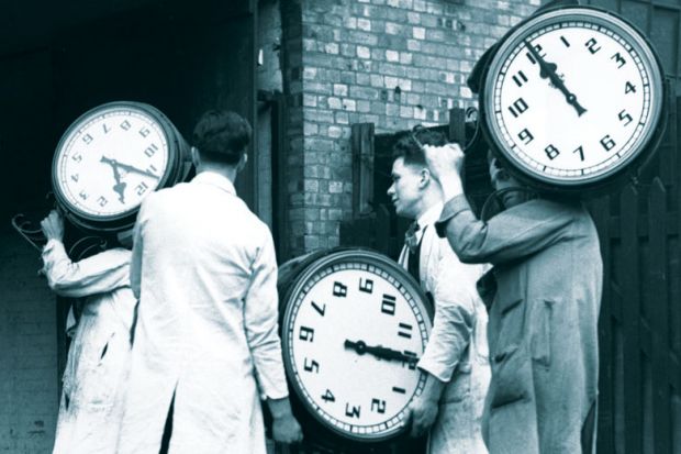 Workers carrying large clocks as Traditional three-hour university exams may soon be a thing of the past as leading UK institutions eye a switch to online and more “authentic” forms of assessment 