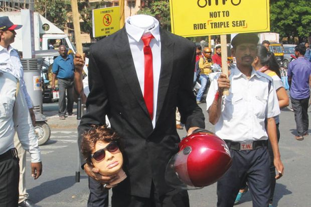 Person dressed headless and holding a dummy head as a metaphor for Indian leadership vacuum raises questions over sector reforms