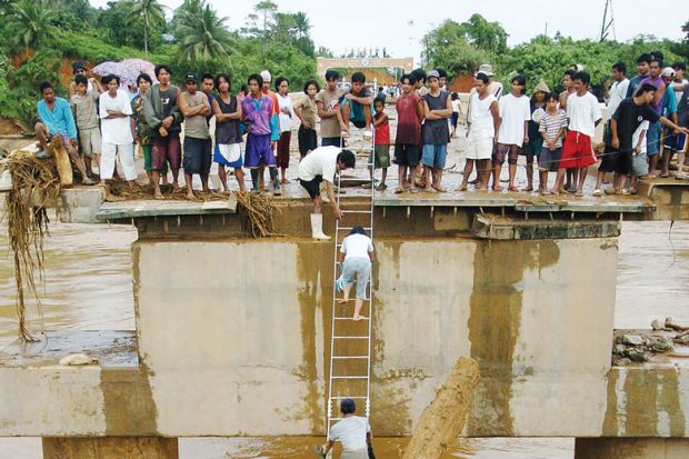  Villagers use an aluminium ladder to cross a concrete bridge as a metaphor for Is South-east Asia  higher education’s next global hotspot