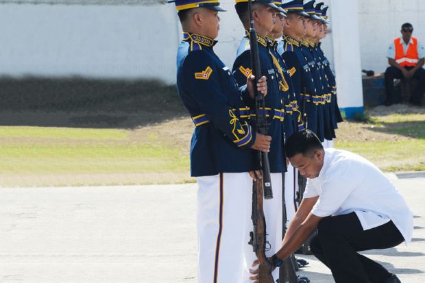 A presidential guard inspects members of the honor guard to illustrate hilippines military training for students ‘aims at stifling dissent’