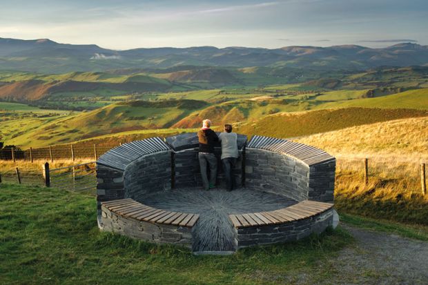 A couple of tourists admiring view of north powys to illustrate Welsh tertiary regulator ‘could be model for England’