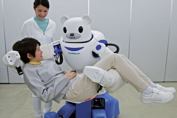 A polar bear robot "Robear" lifting a woman for a demonstration