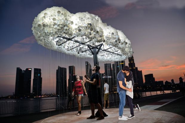Cloud light art installation people walking with a honeymoon couple in front to illustrate Is  the honeymoon period over for liberal arts  in Asia?