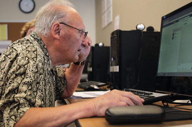 Elderly man at laptop to illustrate UK vice-chancellors staying in posts longer