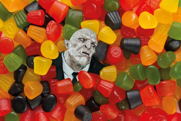 Trolls head surrounded by sweets Trolls head surrounded by sweets to illustrate Universities must help scholars targeted by trolls