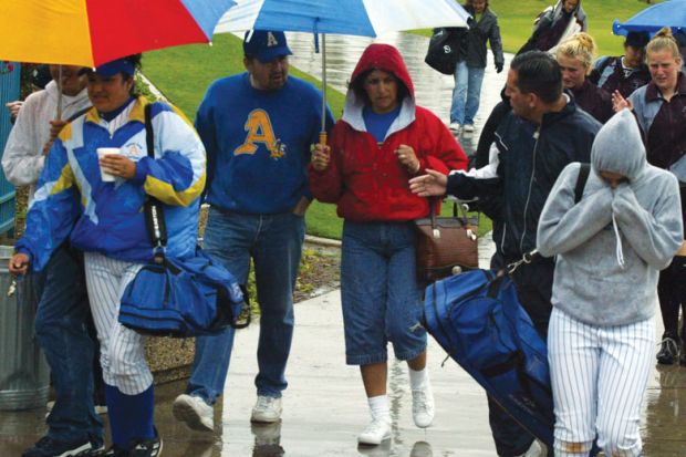 Spectators exit the Woodbridge Softball Classic Tournament which was postponed.