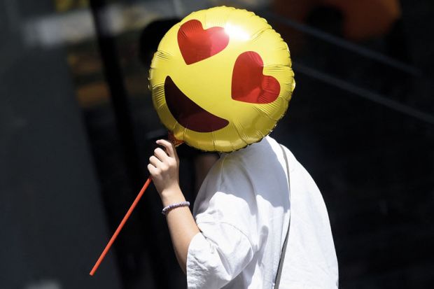 A woman holds a heart emoji balloon to illustrate Rosier outlook for UK sector finances with pension changes excluded