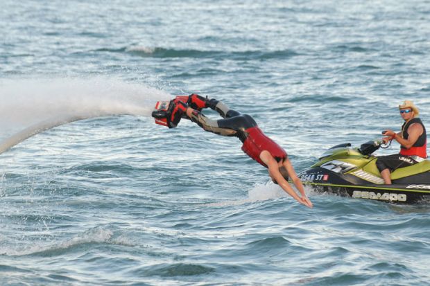 Person dives into the water on a flyboard at the Detroit river front