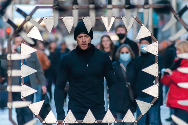 Stunt runner runs and jumps through metalwork surrounded by knives to illustrate Post-92 contract ‘at risk’ in wave of university cost-cutting