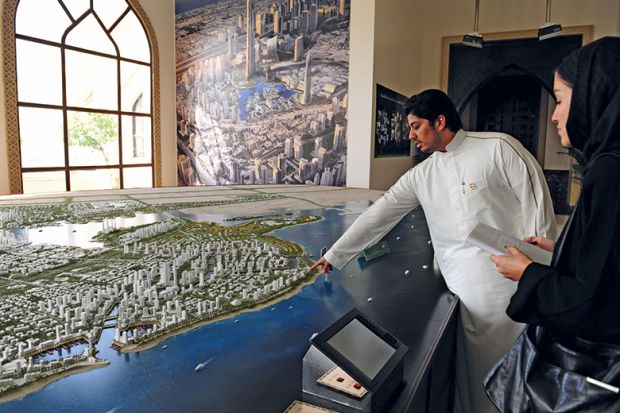 Person shows the architecural model of King Abdullah Economic City in Jeddah