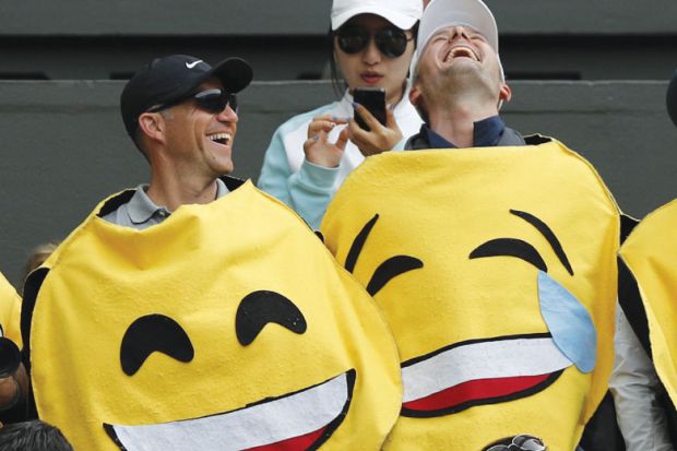 Two men wearing emoji costumes laughing asametaphor for Is optimism justified?