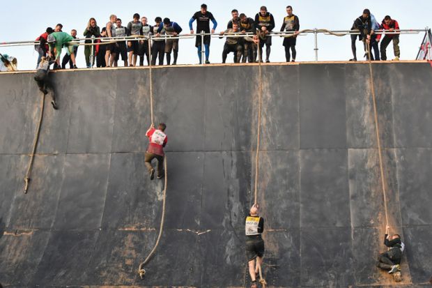 People climbing ropes during the Race of Heroes obstacle course race
