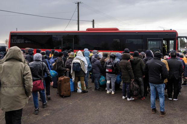 People gather to take a bus as refugees from many countries including India - mostly students of Ukrainian universities are seen at the Medyka pedestrian border crossing fleeing the conflict in Ukraine