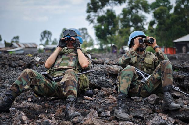 Uruguayan United Nations peacekeepers look through binoculars to illustrate New rules of engagement