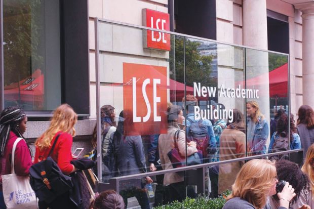Students attending the London School of Economics and Political Science outside the university's New Academic Building, London, UK.