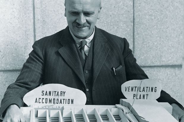 John Burdon Sanderson Haldane (1892-1964) the Scottish geneticist holds an architectural model. 